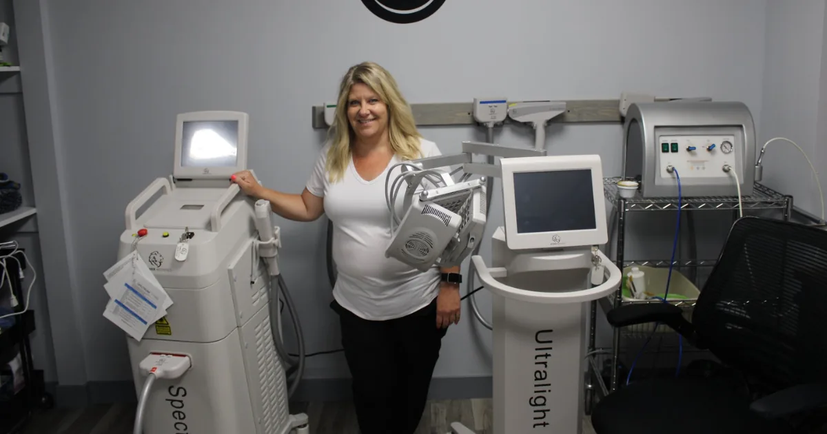 Amy Bassett with esthetics and laser equipment at Harmony Healing Arts in Stuart, Iowa